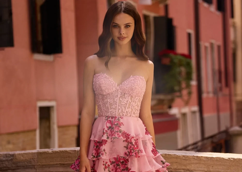 Model wearing circle sunglasses and feathered pink top